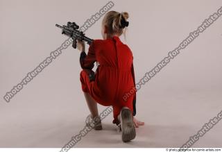 DENISA KNEELING POSE WITH GUN